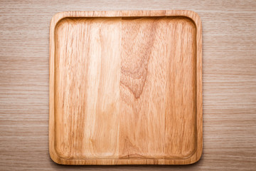 Wood dish on the wooden background.