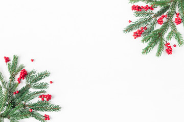 Naklejka na ściany i meble Christmas composition. Fir tree branches and red berries on white background. Christmas, winter, new year concept. Flat lay, top view, copy space