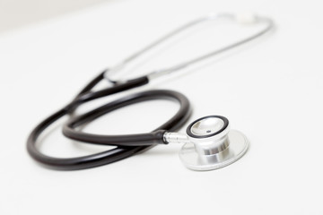 Stethoscope on table. Isolated on white background. Studio lighting. Concept for healthy and medical