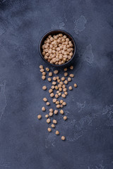 Chickpeas in bowl on dark background