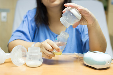 New mother with automatic breast pump. Mother breasts milk is the most healthy food for newborn baby