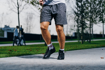 foot athlete, on the sidewalk, in motion
