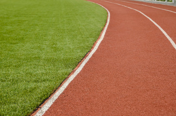 The running track rubber lanes in the artificial grass stadium.