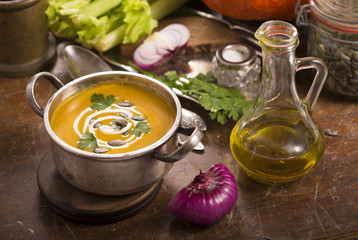 pumpkin soup on rustic wooden background