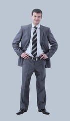 Full-length portrait of a confident businessman isolated on gray