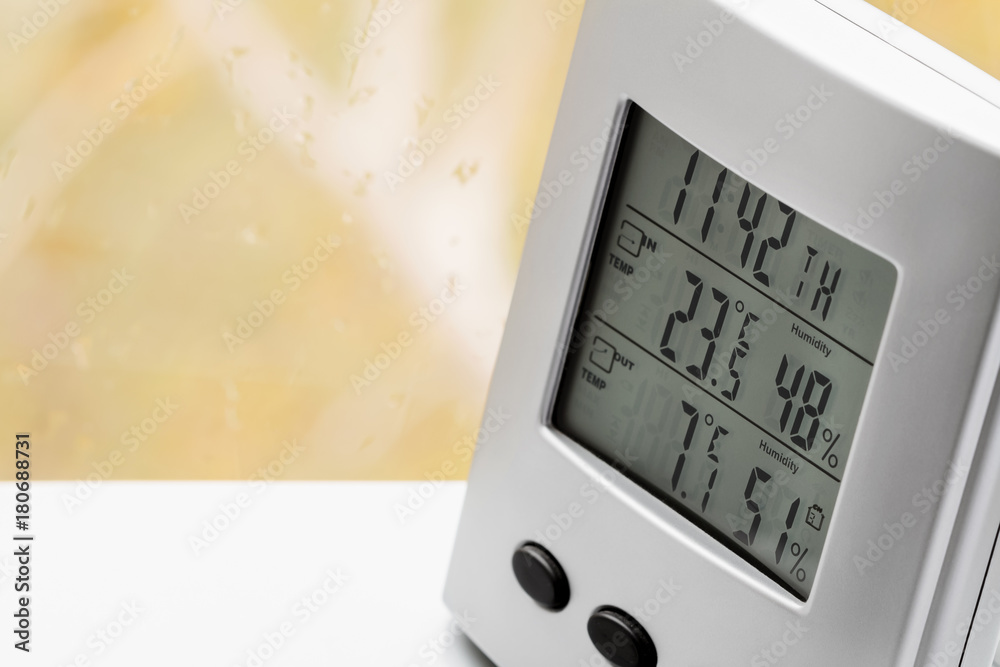Wall mural weather station device with weather conditions inside and outside. background of a window with raind