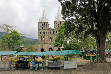 Fototapeta premium Church and main square in colonial city El Jardin, Colombia, South America