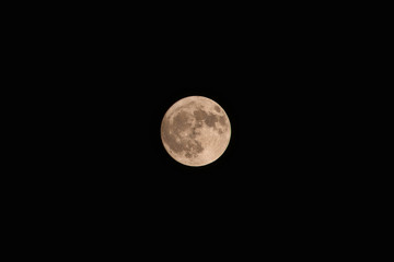 Full yellow moon on dark sky background