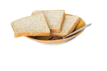 Sliced bread on brown ceramic plate with spoon isolated on white background