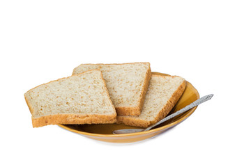 Sliced bread on brown ceramic plate with spoon isolated on white background