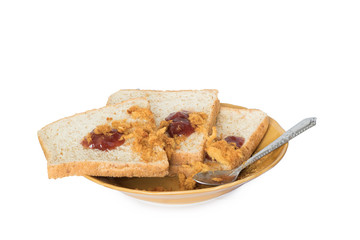 Sliced bread on brown ceramic plate with spoon isolated on white background