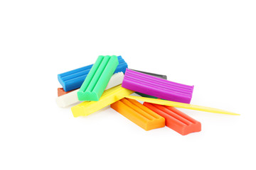 Bright soft plasticine and plastic knife isolated on white background