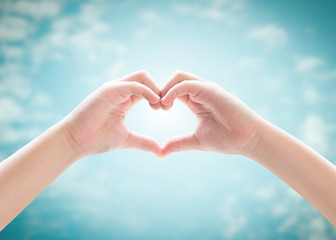 Heart-shape hand gesture of kid's body language for children's love, peace, kindness and world...