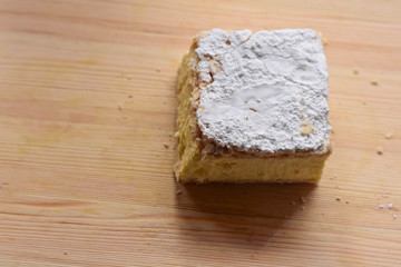 Sweet cream pie slice on a wooden background/ top view