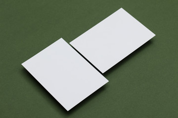 Blank white postcard on a green background