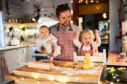 Young Family Making Cookies At Home.