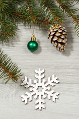 Natural fir tree branches with cone, ball and decorative snowflake