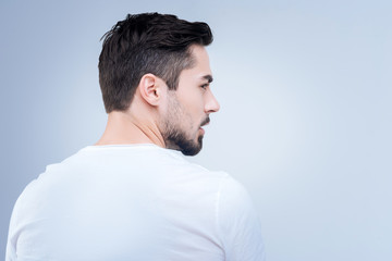 Obraz premium Turn away. Serious stubborn young man turning away and looking to the right while rejecting to communicate with anyone