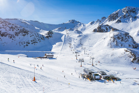Sunny day in the Austrian Alps - ski tracks, ski lifts and snowy mountains