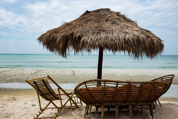 umbrella of reeds. chair and sofa on the beach Cambodia