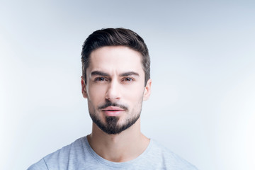 Fototapeta premium So beautiful. Cheerful pleased young man looking happy while admiring the beautiful photos in a new gallery