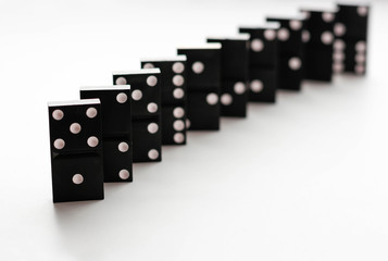 Domino standing on edge. Isolated on a white background. Closeup