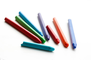 Colored wax crayons. Isolated on a white background. Closeup