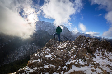 Naklejka premium Hiker standing on the top of a hill in Tatra mountains, Poland
