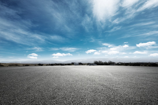 empty asphalt road with snow mountains in blue cloud sky
