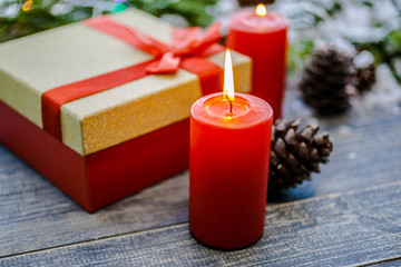 Burning candles and Christmas giftbox. Background for the New Year's or Christmas card