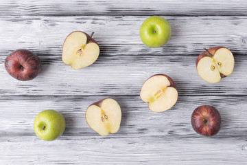 Sliced apples on white wooden background