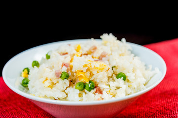Homemade Chinese fried rice with vegetables and fried eggs