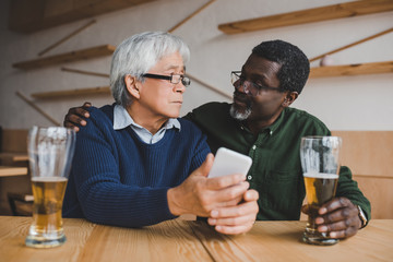 senior friends drinking beer
