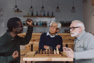 senior friends playing chess