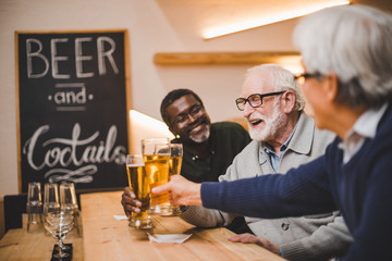 senior friends drinking beer together