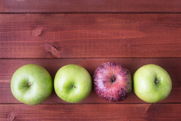 Top view of ripe apples on wooden background with copy space