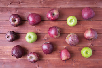 Top view of ripe apples on wooden background