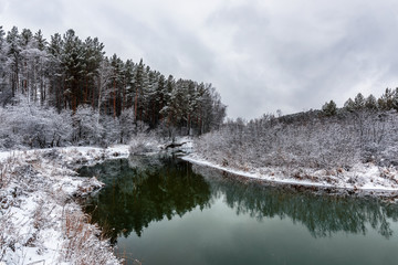 A cooling river with the first snow on the shore