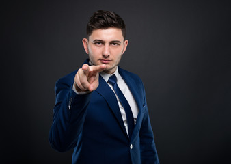 Male entrepreneur making watching you gesture