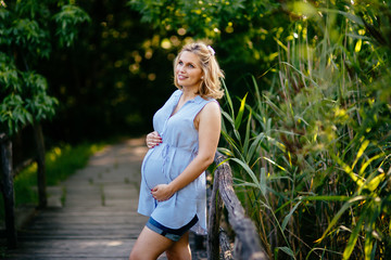 Beautiful pregnant woman in nature