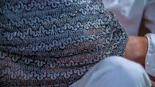 A young man and woman are passionately kissing on a couch. He is passionately grabbing her booty. 