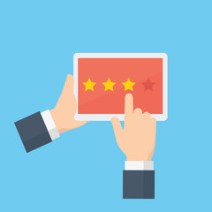People hand giving star rating on a tablet, customer review, rating, user feedback concept