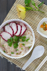Shrimp Wonton and Pork red roasted in white bowl on bamboo grille and  wooden table