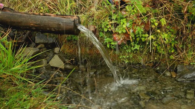 washing hands with water from a mountain spring