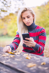 Young woman looking at her phone
