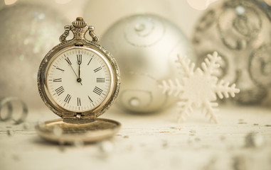 SIlver christmas balls and golden new year watch