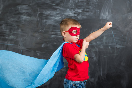 boy superhero in a blue Cape red mask and a red t-shirt with a star
