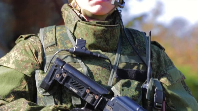 Portrait of young russian soldier. Soldier with automatic rifle. Closeup. Front view