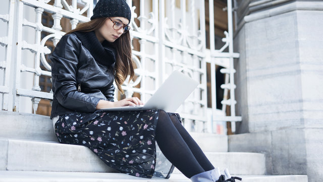 Young woman using laptop in outdoors