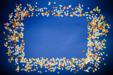 Square frame of paper flowers on a blue background